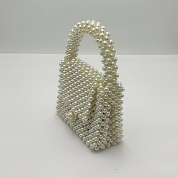 Pearl-handled bag on a white background