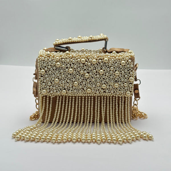 Handbag with pearl embellishments on a white background