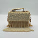 Handbag with pearl embellishments on a white background