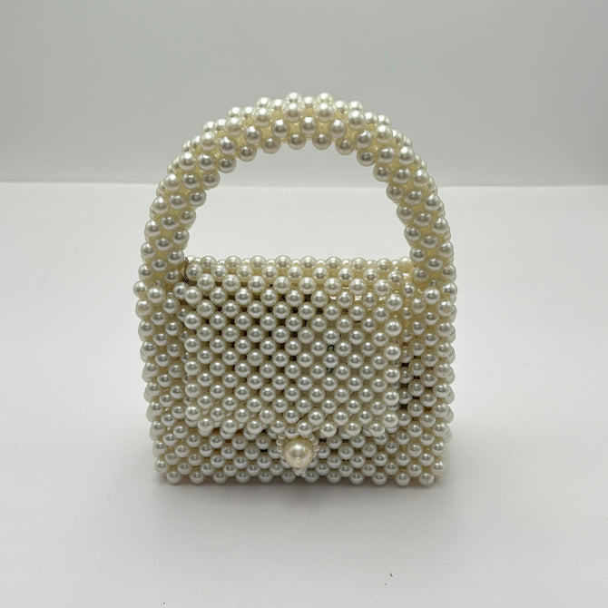 Pearl-handled handbag on a white background